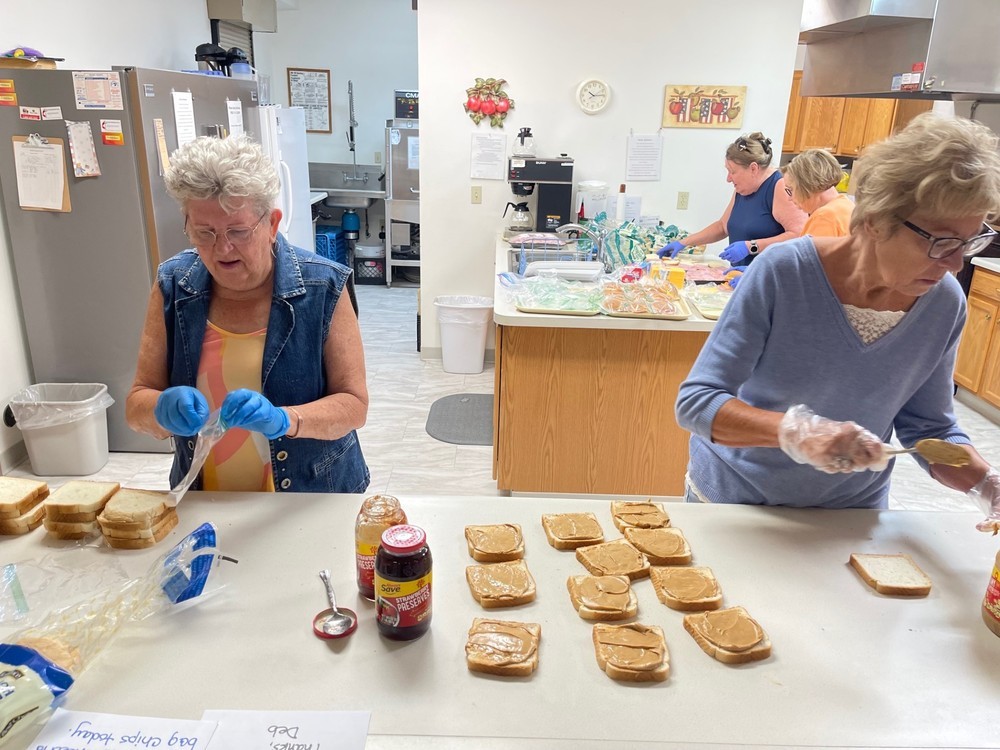 Women making PBJ sandwiches