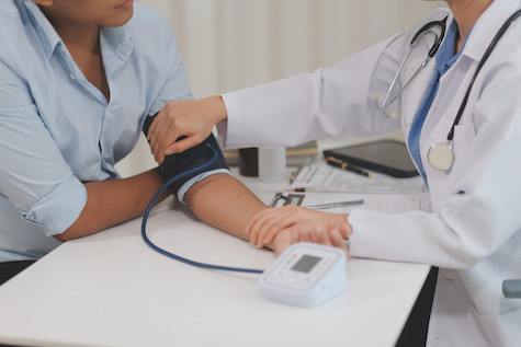 arms measuring blood pressure