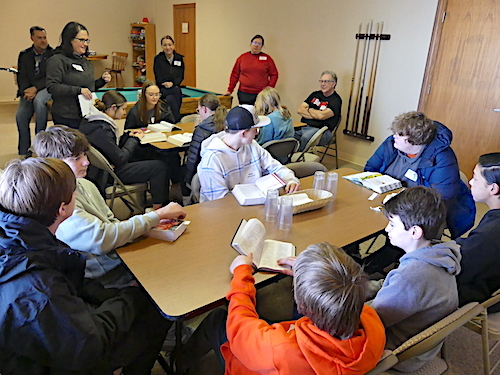 Students gathered around tables