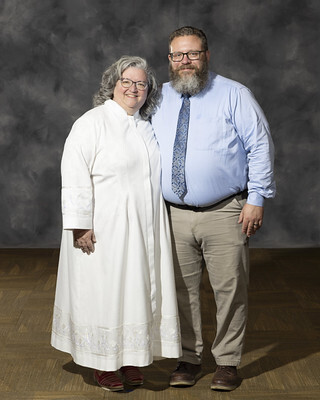 Pastor standing with husband